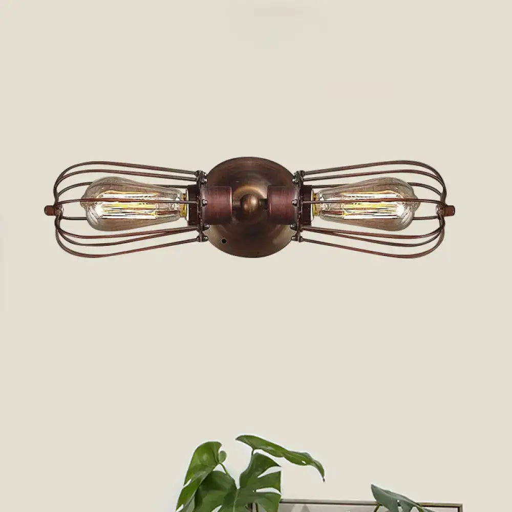 Antique style black bronze sconce light with two exposed Edison bulbs in a rustic wire cage for dining room wall