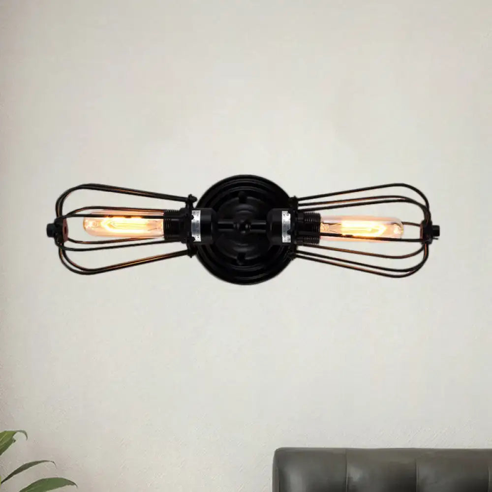 Black bronze antique style wrought iron sconce light with two exposed filament bulbs in wire cages for dining room
