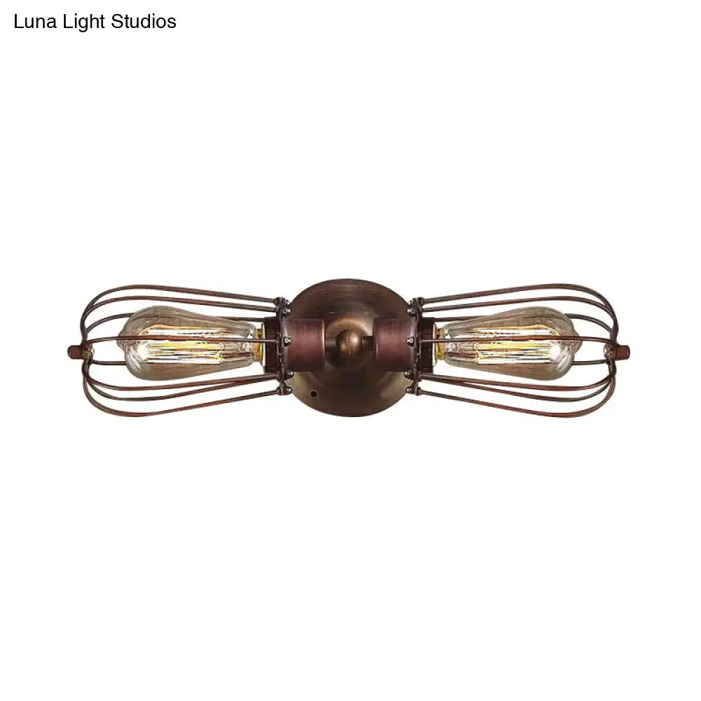 Antique style black bronze sconce light with two filament bulbs in wire cages and bronze metal base for dining room