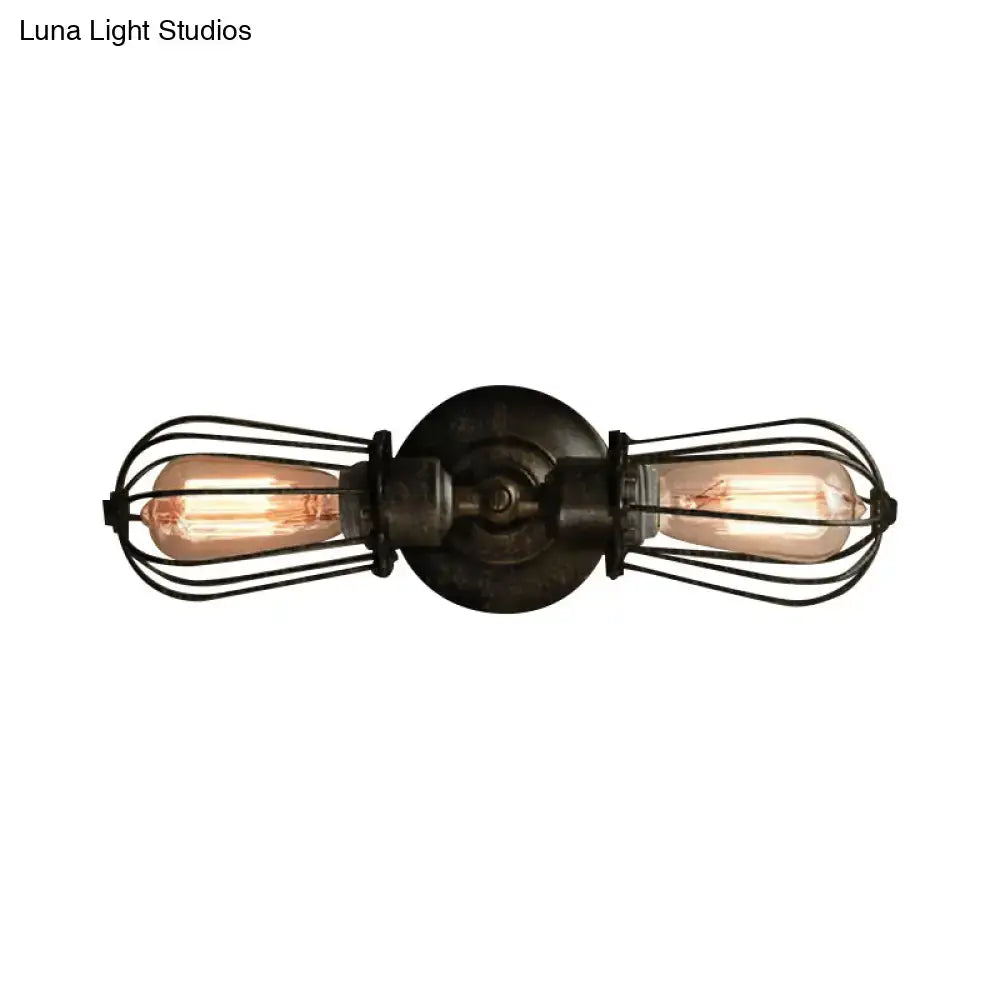 Antique style black bronze sconce light with two exposed filament bulbs and dark metal wire cages for dining room wall