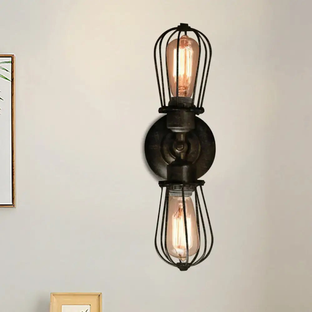 Antique style black bronze sconce light with two exposed edison bulbs in wrought iron cages for dining room wall