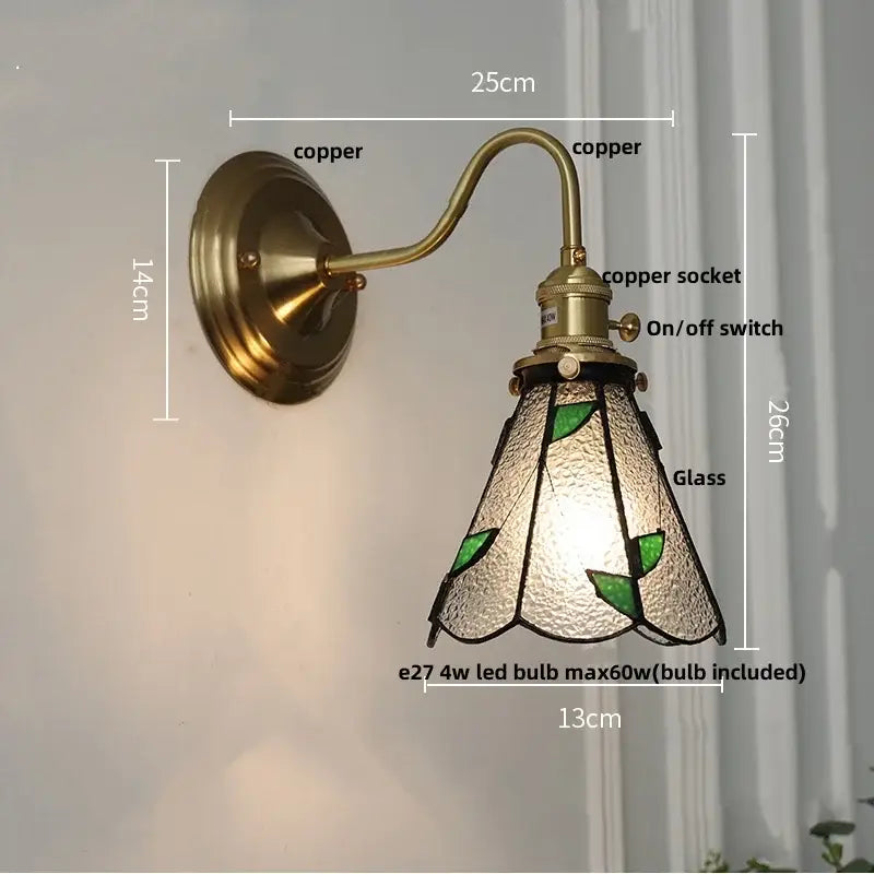 Antique teal glass and brass wall light fixture with vintage copper sconce and textured shade featuring green leaf motifs