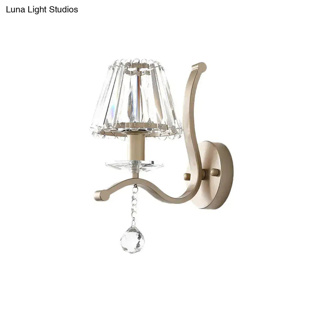 Elegant antiqued gold wall mount light fixture with champagne finish faceted crystal shade and teardrop pendant for bedroom