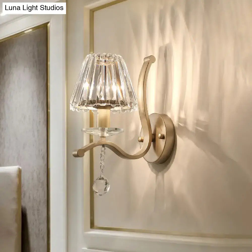 Elegant antiqued gold wall mount light fixture with fluted crystal shade and faceted crystal drop for bedroom sconce