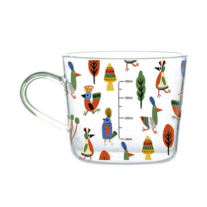 Clear 500ml glass mug decorated with apricot and orange patterned birds and trees for kitchen breakfast use