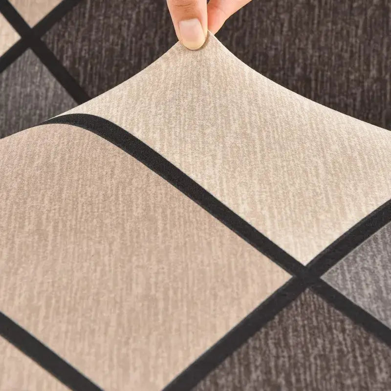 Beige and black geometric patterned argyle elastic armless futon sofa cover with textured woven fabric for living room