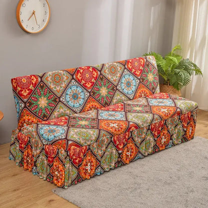 Vibrant elastic armless futon sofa cover with bold geometric mandala pattern in reds, oranges, blues, and greens with brown borders