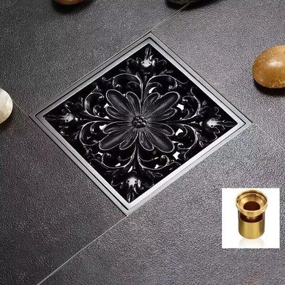 Black brass shower drain cover with ornate floral design set in square frame for decorbites black brass collection