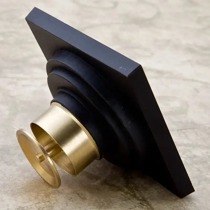 Art carved black brass and gold shower drain cover with tiered fluted decorative base for black brass shower use