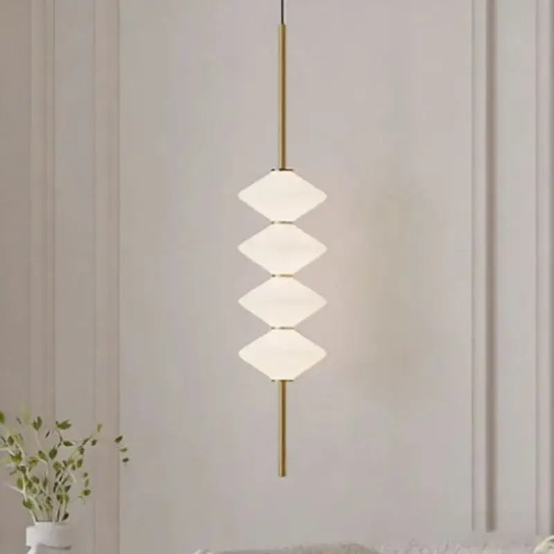 Art deco pendant light with four white frosted glass diamond shades on a gold-toned metal rod for dining room