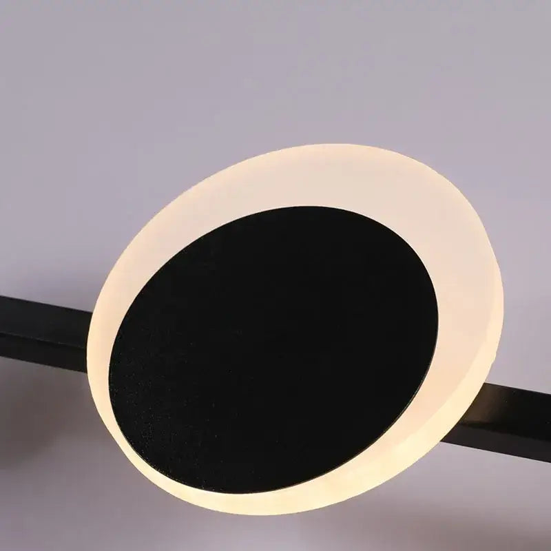 Modern art deco led circular ceiling light with white outer ring and black inner circle emitting warm glow for dining room decorbites art deco