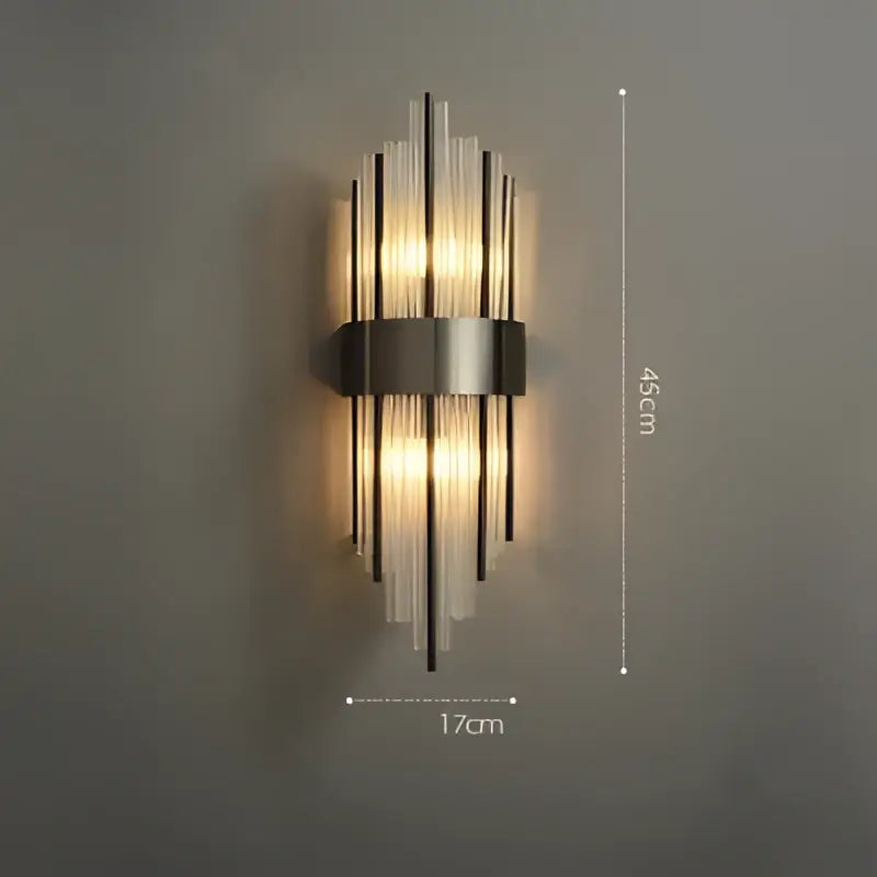Art deco black and gold stainless wall sconce with ribbed glass rods featuring warm light for decorbites art deco use