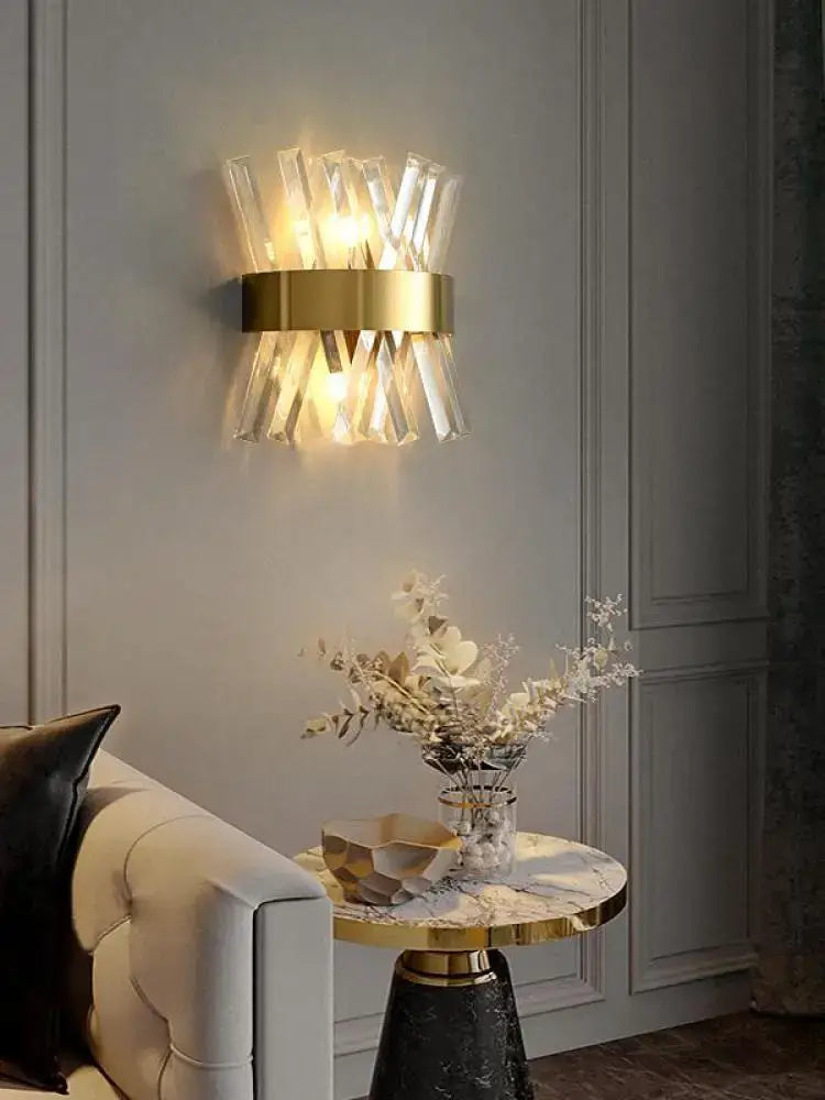 Gold-toned art deco stainless wall sconce with clear crystal prisms for bedroom decorbites art deco lighting