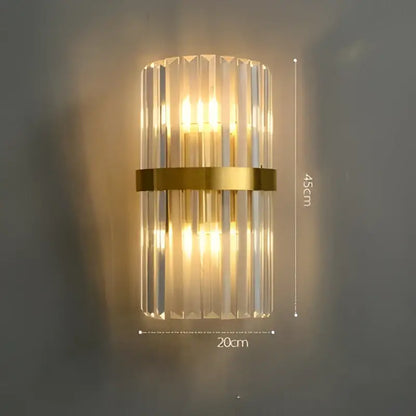 Modern art deco stainless wall sconce with vertical crystal rods and gold-toned metal band for bedroom decorbites design