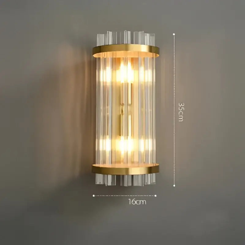 Gold-toned decorbites art deco stainless wall sconce with vertical clear ribbed glass rods and warm glowing lights for bedroom decor