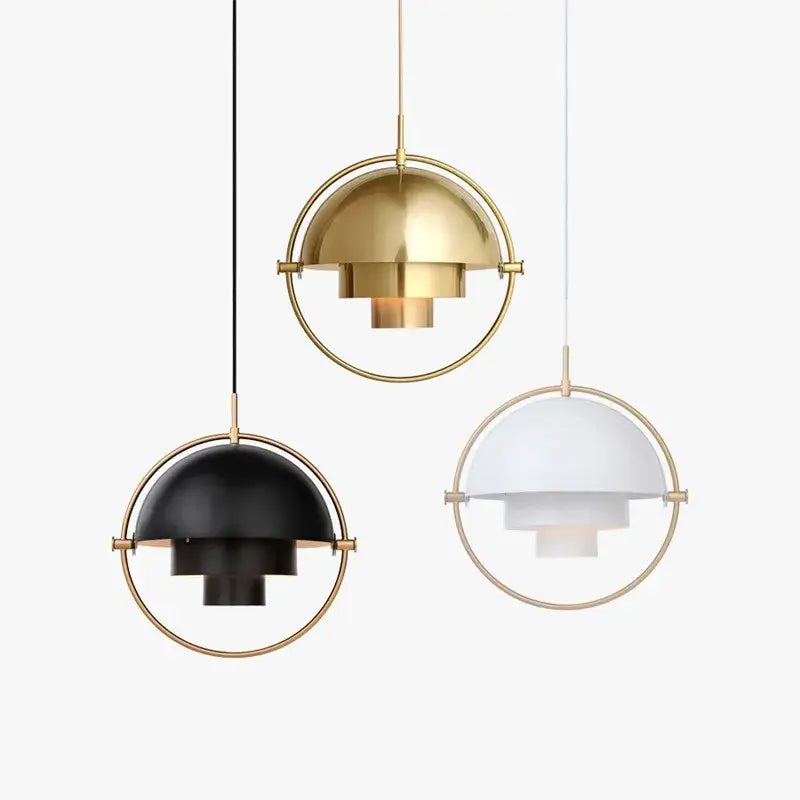 Three art deco pendant lights with layered dome design, gold-toned brass frames, and black, white, and brass bulb bases for dining room