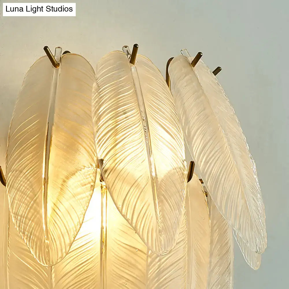 Elegant translucent glass feather chandelier with gold-toned metal accents for dining room leaf sconce lamp with clear glass