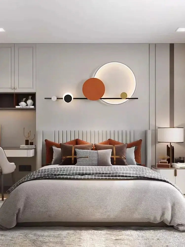 Art deco geometric orange and gold led wall sconce featuring a modern black bar with three circular elements