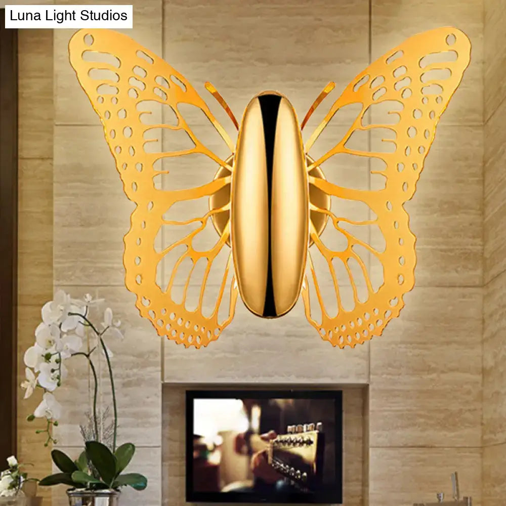 Gold butterfly wall sconce with intricate cutout wings and sleek polished metal body for kids room lighting