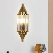 Art deco gold finish wall light with crystal prisms and geometric metal framing for living room lighting