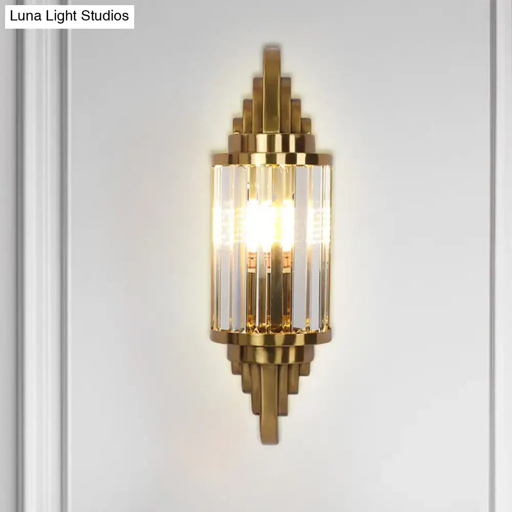 Art deco gold finish wall light with crystal prisms and geometric brass accents for elegant living room decor