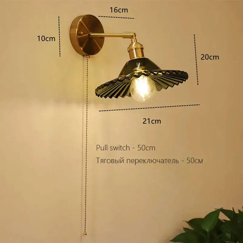 Brass-finished art deco led wall lamp with fluted dark green glass shade and exposed bulb for bedroom decorbites sconce