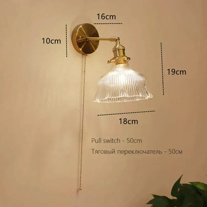 Brass-finished decorbites art deco led wall lamp with clear ribbed glass shade and adjustable pull-chain switch for bedroom decor