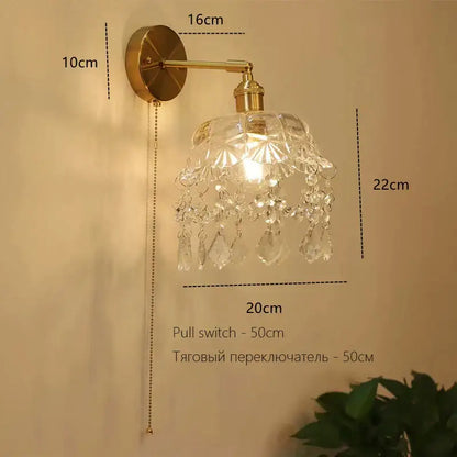 Art deco led wall lamp with brass sconce and ornate crystal glass shade featuring faceted dangling crystals decorbites art deco