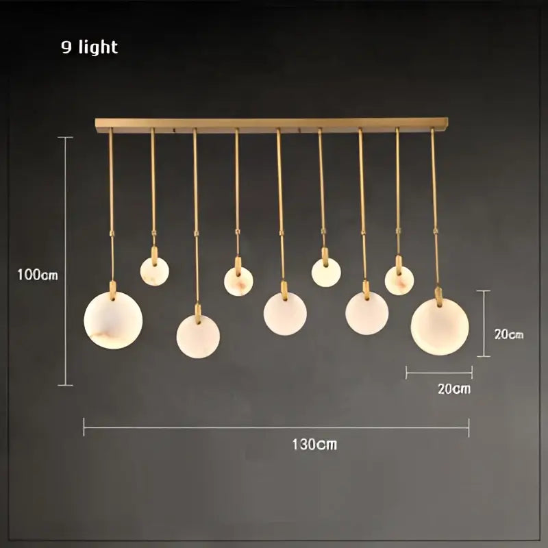 Art deco marble golden lustre pendant light featuring a gold-toned chandelier with nine frosted glass shades for dining room