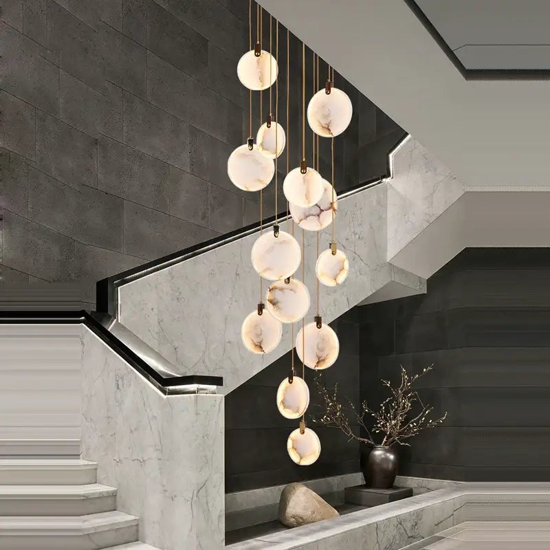 A modern art deco marble golden lustre pendant light with spherical translucent shades for dining rooms