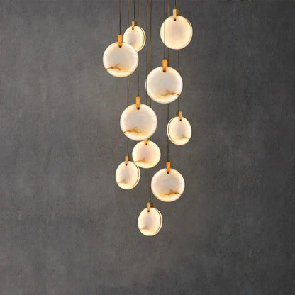 Art deco marble golden lustre pendant light with translucent white opal discs and gold-toned hardware for dining room