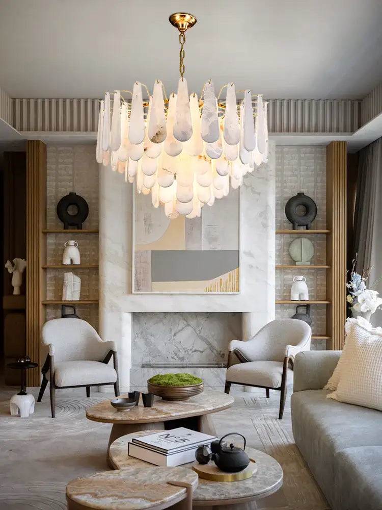 A modern art deco marble tiered led chandelier with cascading white glass teardrops and gold-toned frame for decorbites decor marble home