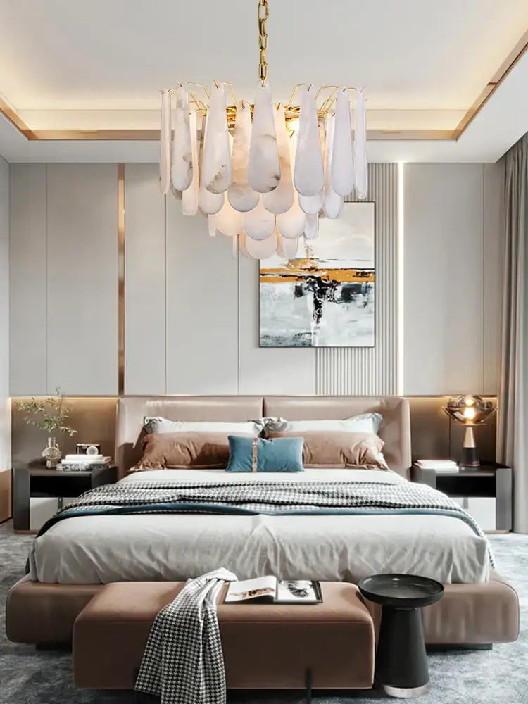 A modern art deco marble tiered led chandelier with cascading white teardrop glass pendants and gold chain decorbites art deco