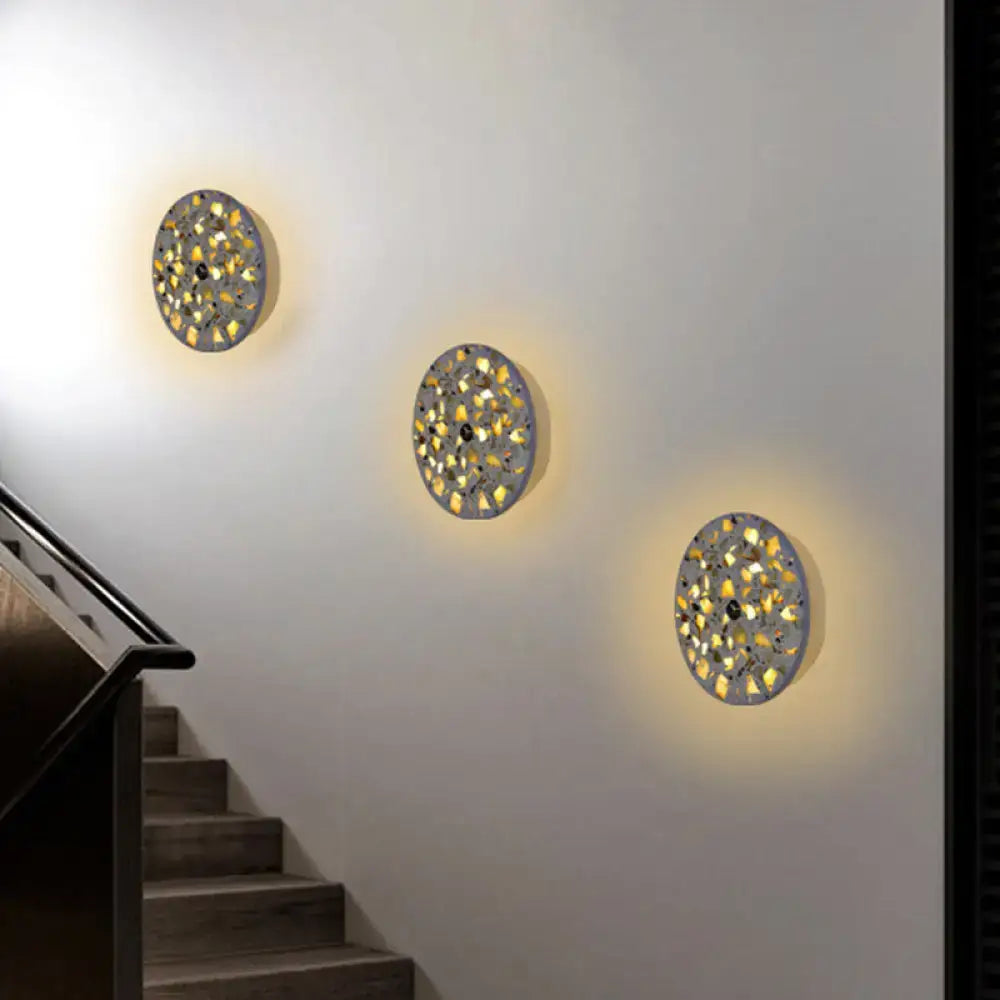 Three circular art deco mosaic terrazzo led wall sconces with metallic frames and golden-yellow glass for living room lighting