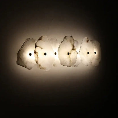 A modern off white marble led wall sconce with five translucent alabaster-like panels for elegant bedroom decorbites elegant marble lighting