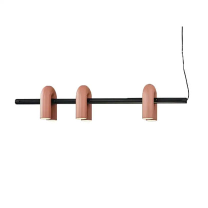 Modern art deco pendant light with three matte pink u-shaped metal lampshades on black bar for dining room chandelier