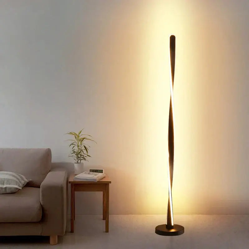 Modern twisted gold floor lamp with sleek art deco design and warm ambient lighting from decorbites art deco collection