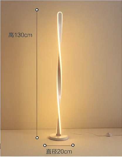 A sleek art deco floor lamp with a twisted glowing gold design and metallic base for living room decorbites ambient light