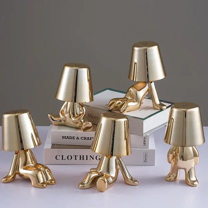 Articulated golden man table lamp with glossy ceramic abstract human form and lampshade head ideal as night light