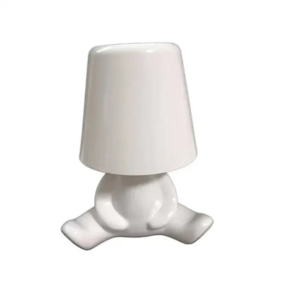 White ceramic night light with rounded minimalist design resembling a seated figure for golden man table lamp