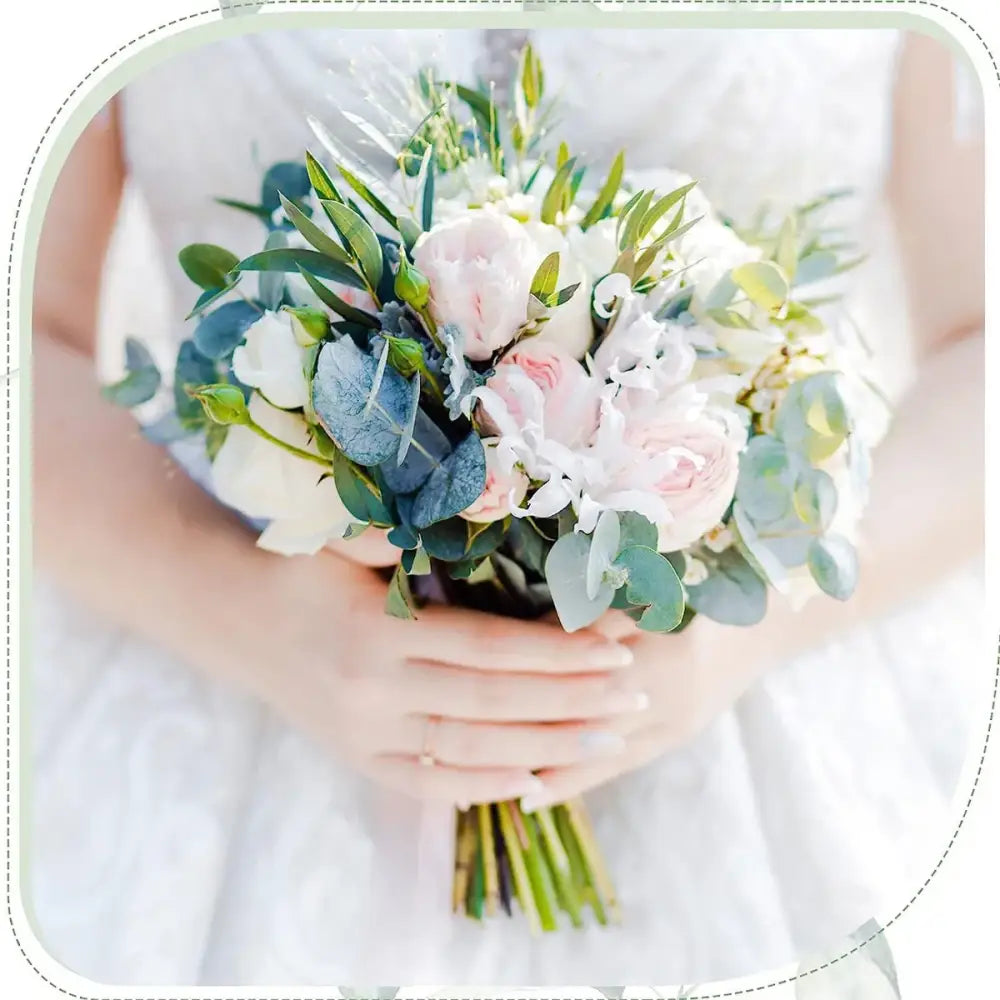 A delicate bridal bouquet with soft pink and white roses and silvery-blue eucalyptus from 30pcs artificial flower plants