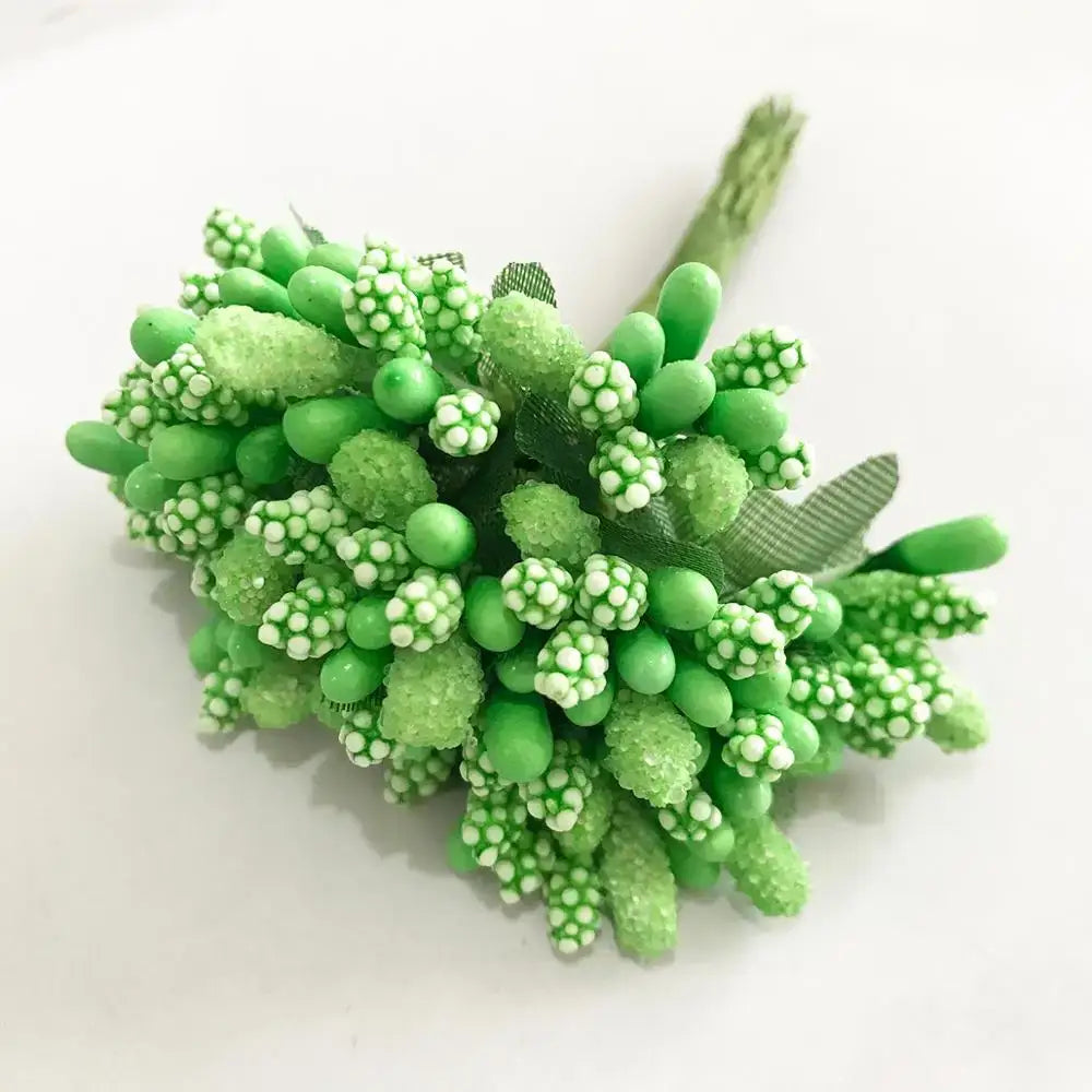 A cluster of artificial green plant flower cherry berries with white speckled accents and a mesh stem for decorbites green plant decor