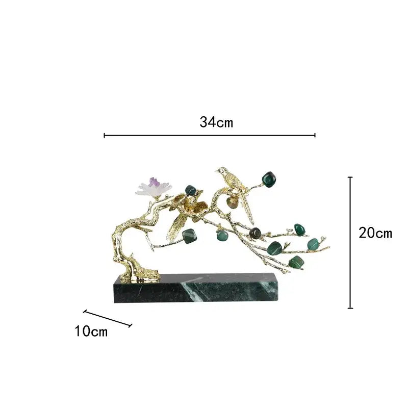 Artisan golden tree handicraft with golden bird and floral branch ornament featuring green gemstones on dark marble base