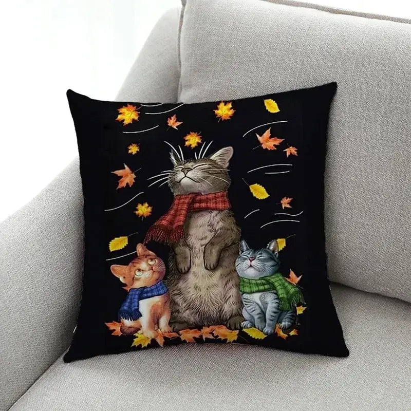 Black throw pillow with artistic cat print featuring three cats in autumn scarves and falling leaves for living room decorbites cat print decor