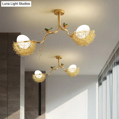 Gold-toned DecorBites™ chandelier pendant with milk white glass balls and hand-sewn aluminum nests with birds