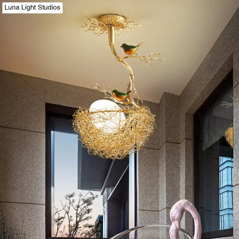 Golden bird-themed ceiling light fixture with milk white glass ball and hand-sewn aluminum nest pendant chandelier