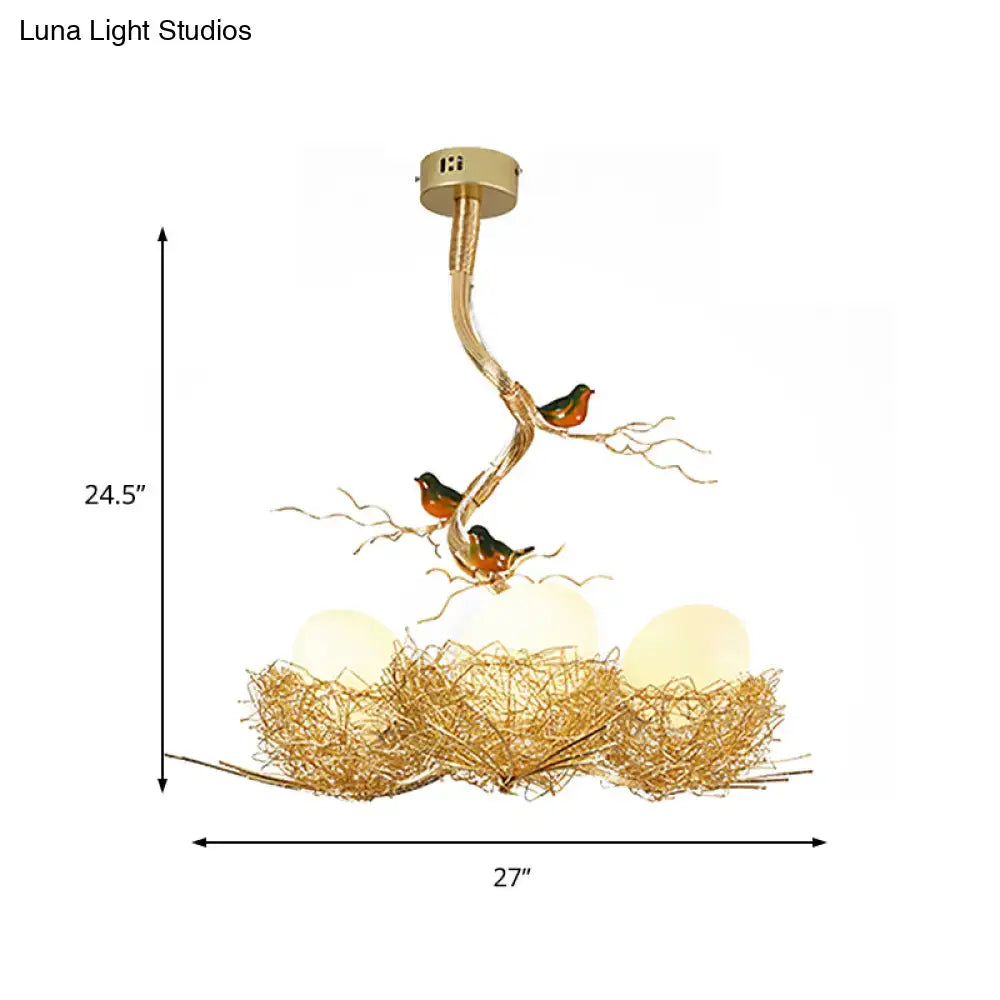 Gold-toned chandelier pendant with artistry milk white glass balls featuring bird and hand sewn aluminum nest design