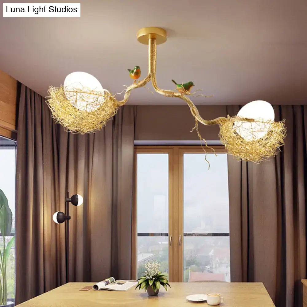 Golden bird’s nest chandelier pendant featuring artistry milk white glass balls with two birds and hand sewn aluminum nest