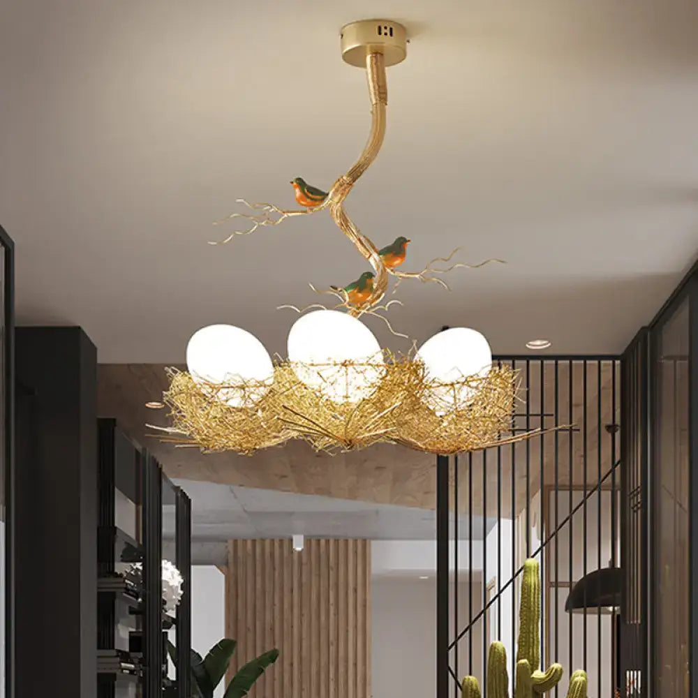 Golden chandelier pendant with artistry milk white glass balls nestled in a hand sewn aluminum bird nest design
