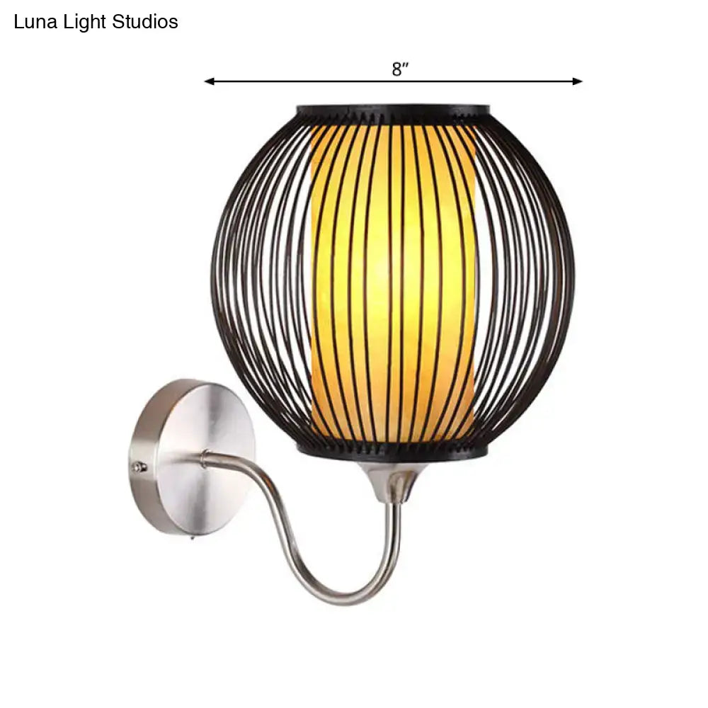 Asian style black bamboo gooseneck wall lamp with black wireframe spherical wall light and warm yellow illumination